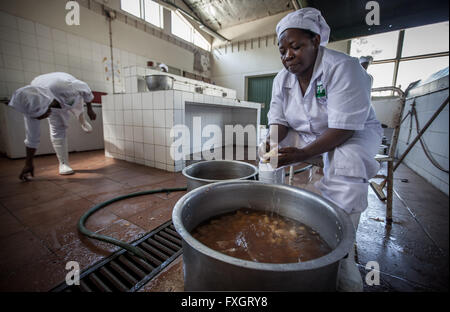Mozambique, a woman is cooking traditional cousin. Stock Photo