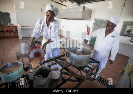 Mozambique, women are cooking in bakery traditional cousin. Stock Photo