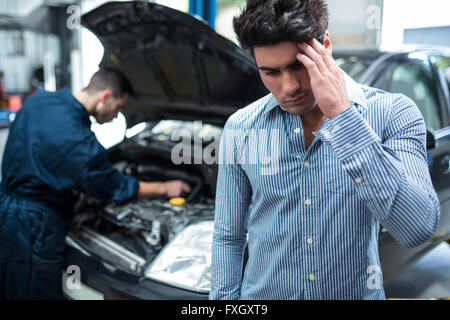 Customer feeling worried about his car Stock Photo