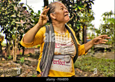 A Javaese woman seller of jamu, traditional Indonesian medicine, which she makes herself from herbs. Stock Photo