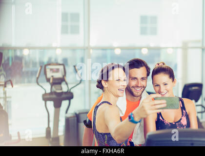 Smiling friends taking selfie at gym Stock Photo