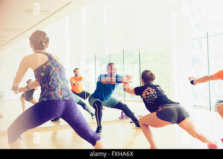Fitness instructor leading exercise class Stock Photo