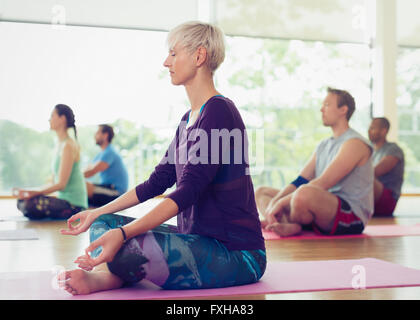 Serene woman in lotus position in yoga class Stock Photo