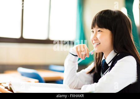 happy pretty  student girl with books in classroom Stock Photo