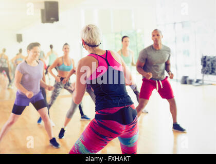 Fitness instructor leading aerobics class Stock Photo