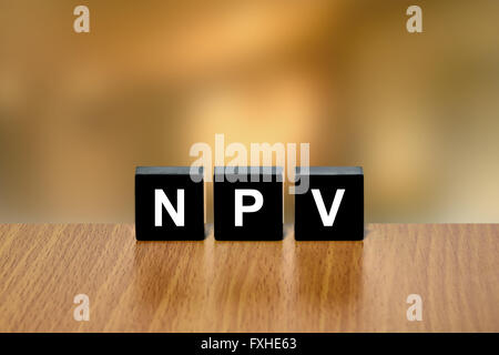 NPV or Net Present Value on black block with blurred background Stock Photo