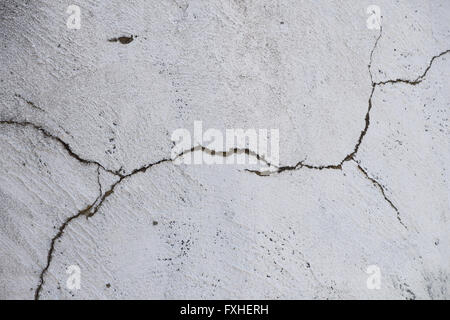 Damage split crack in white painted plaster concrete wall background Stock Photo