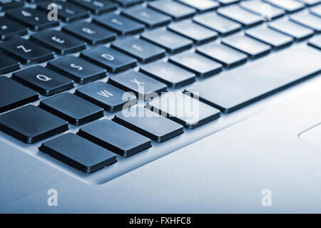 Keyboard from laptop with cyanotype saturation and fine shallow of field Stock Photo