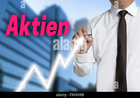 aktien (in german shares) trader draws market price on touchscreen. Stock Photo