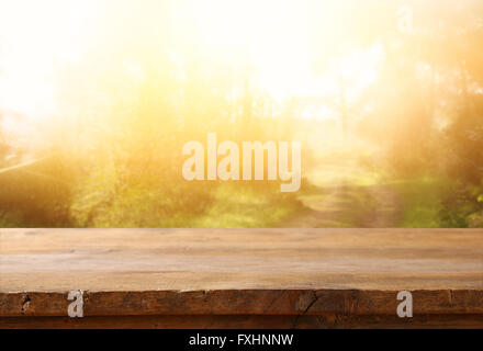 front rustic wood boards and abstract forest background. vintage filtered and toned. Stock Photo