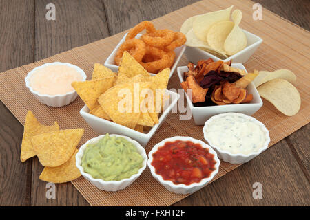 Crisp and dip party food selection in porcelain bowls over bamboo and oak. Stock Photo