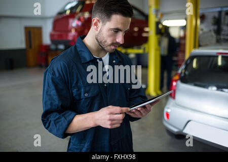 Mechanic using digital tablet Stock Photo