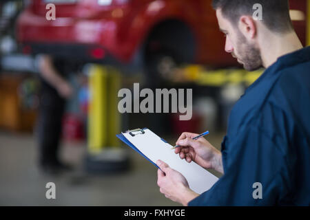 Mechanic preparing a check list Stock Photo