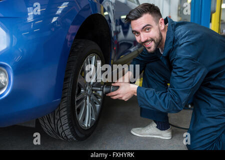 Mechanic fixing a car wheel Stock Photo