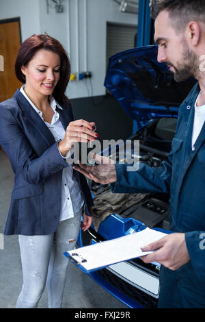 Customer giving her car keys to mechanic Stock Photo
