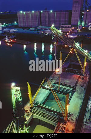 Night view of loading grain from silos onto a freighter ship in the Houston Texas Ship Channel; Texas; USA Stock Photo