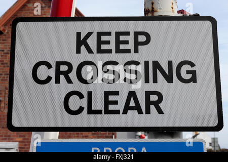 A level crossing 'Keep Crossing Clear' sign in Brora, Scotland, UK Stock Photo