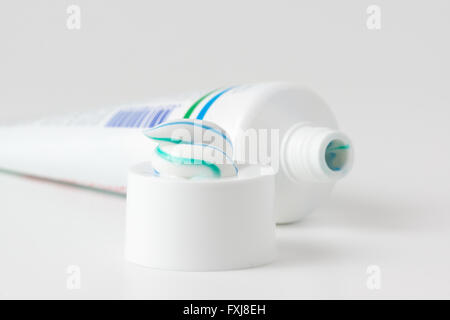 toothpaste tube with a small amount of toothpaste on the cap Stock Photo