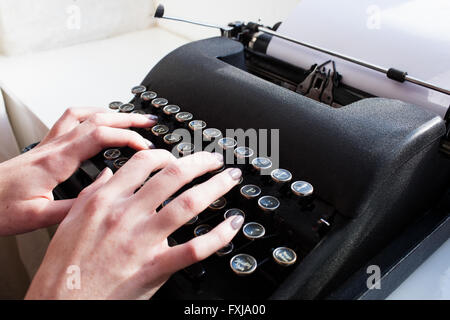 Womans hand typing on typewriter Stock Photo