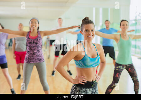 Portrait smiling fitness instructor leading aerobics class Stock Photo