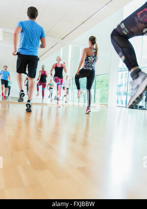 Fitness instructor leading aerobics class Stock Photo