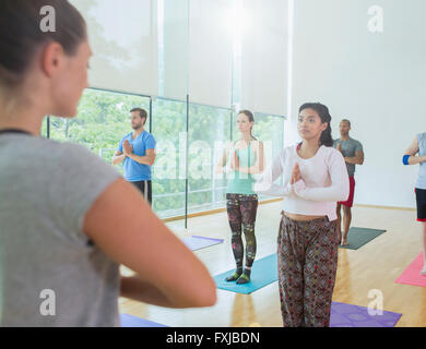Yoga class with hands at prayer position Stock Photo