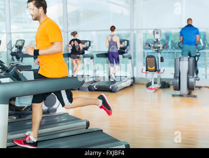 Man running on treadmill at gym Stock Photo