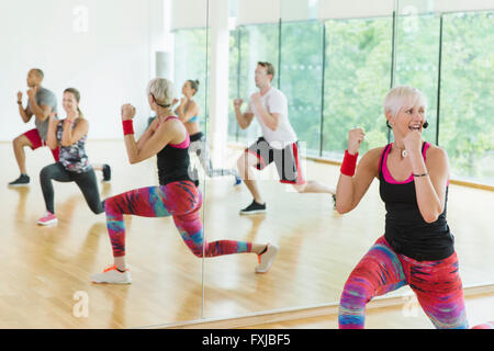 Fitness instructor leading aerobics class Stock Photo