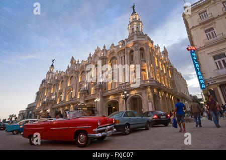 Horizontal close up of a vintage American car parked infront of the Grand Theatre at sunset in Havana, Cuba. Stock Photo