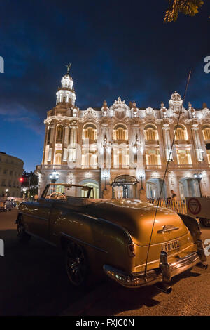 Vertical close up of a vintage American car parked infront of the Grand Theatre at sunset in Havana, Cuba. Stock Photo