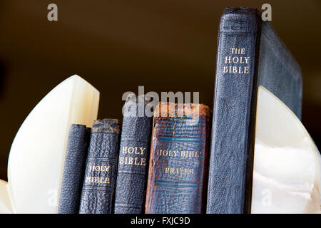 Bibles and prayer books between bookends Stock Photo