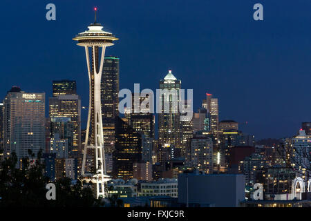 Space Needle with city skyline lights in Seattle, Washington WA at dusk, twilight architecture in downtown core, buildings at night Stock Photo