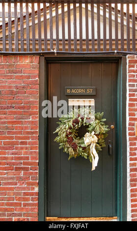 Christmas wreath on a green  wooden door , Acorn St ,Beacon hill, Boston ,MA , USA Stock Photo