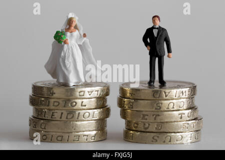 Close up/macro model stock photo depicting married husband and wife on £1 pound coin stack Stock Photo