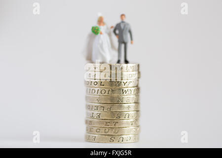 Close up/macro model stock photo depicting married husband and wife on £1 pound coin stack Stock Photo