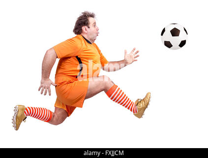 recreational fat football player kicking the ball isolated on a white background Stock Photo