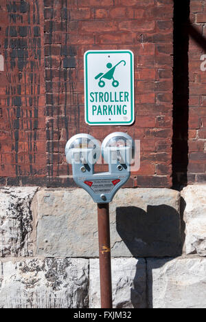 A tongue in cheek sign above parking meters for reserved stroller parking at Toronto's popular Distillery tourist area. Stock Photo