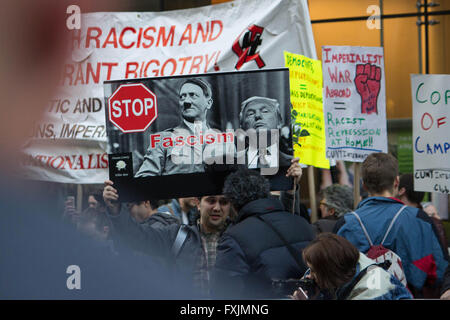 Stop Fascism- An anti-Trump demonstrator holds up a sign that likens Republican candidate Donald J.Trump to Adolf Hitler Stock Photo