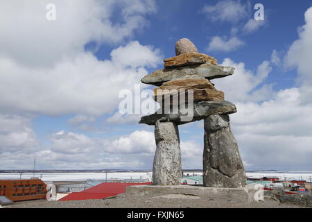 Inukshuk (or Inuksuk) at top of the hill in the community of Rankin Inlet, Nunavut near Hudson Bay, Canada Stock Photo