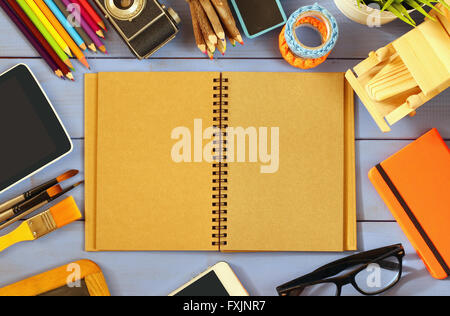 top view photo of blank notebook, old camera and school supplies on wooden table. vintage filtered Stock Photo