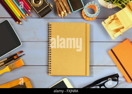top view photo of blank notebook, old camera and school supplies on wooden table. vintage filtered Stock Photo