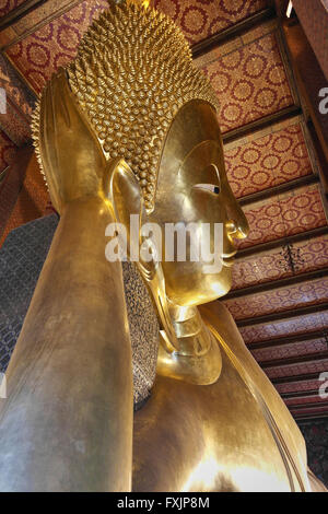 Big Reclining Golden Buddha Statue in Bangkok - Thailand Stock Photo