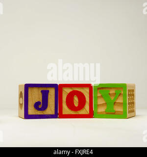 Kid's building blocks spelling the word joy. Stock Photo