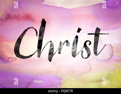 The word 'Christ' written in black paint on a colorful watercolor washed background. Stock Photo