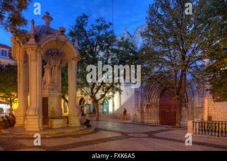 Largo do Carmo square with drinking fountain Chafariz do Carmo in front of Convento do Carmo at dusk, old town Chiado, Lisbon Stock Photo