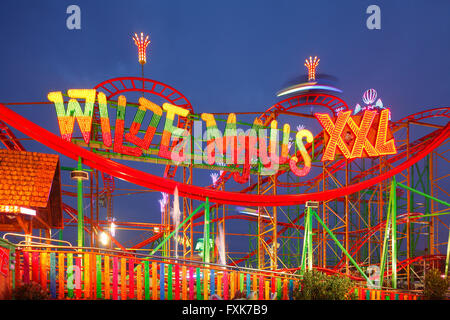 Wild Mouse ride on the fun fair Bremer Freimarkt at dusk, Bremen, Germany Stock Photo