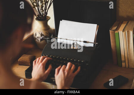 Young woman using typewriter Stock Photo