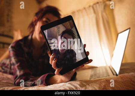 Young woman showing digital tablet Stock Photo