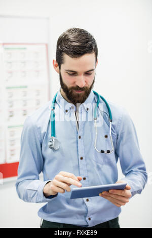 Doctor using digital tablet Stock Photo
