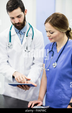 Vets using digital tablet Stock Photo
